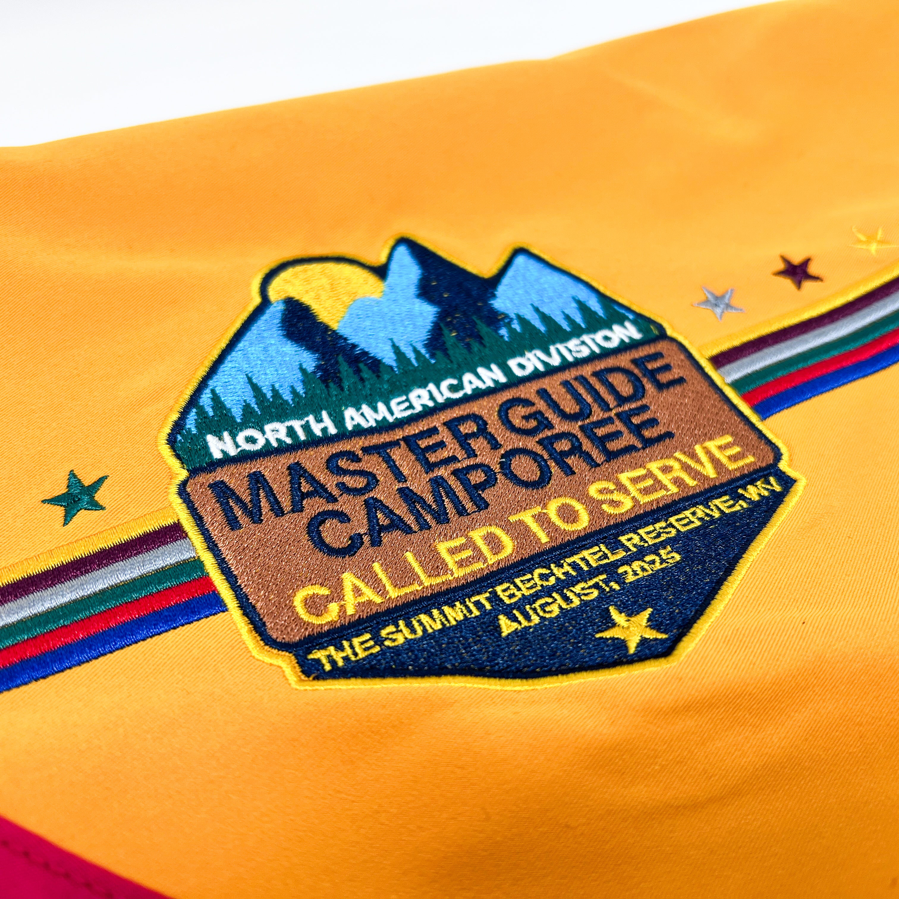 Embroidered patch on a yellow background with text and mountain design.